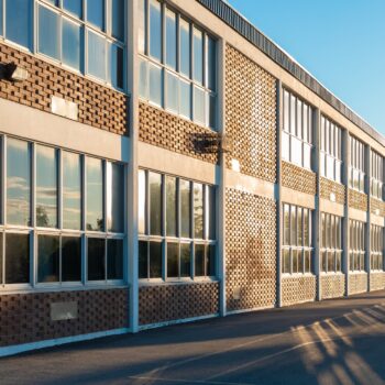 School building and schoolyard in the evening